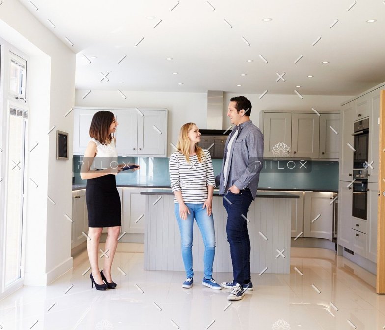 demo-attachment-103-realtor-showing-young-couple-around-property-for-PDHK2DX